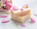 Two Bars of Soap Adorned with Delicate Pink Rose Petals on Grey Surface Royalty Free Stock Photo