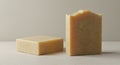 Two bars of soap are placed on a smooth, light-colored surface. One bar is standing Royalty Free Stock Photo
