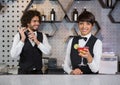 Two bartenders preparing cocktail and serving in bar counter Royalty Free Stock Photo