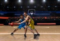 Two basketball players in scrimmage during basketball match