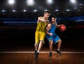 Two basketball players in scrimmage during basketball match