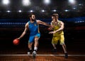 Two basketball players in scrimmage during basketball match