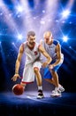 Two basketball players in spotlights Royalty Free Stock Photo