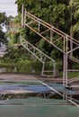 Two basketball wooden backboards with the hoop metal rings and the white and red net on the cement court are at old cemetery park Royalty Free Stock Photo