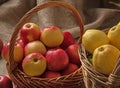 Two baskets with different varieties of apples on a burlap Royalty Free Stock Photo