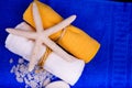 Two bath towels with starfish and sea salt on blue Royalty Free Stock Photo