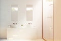 Two bathroom sinks with mirrors, toned