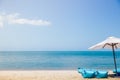 Two beach beds and white umbrella on the tropical beach Royalty Free Stock Photo