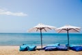 Two beach beds and white umbrella on the tropical beach Royalty Free Stock Photo