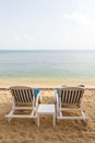 Two beach chairs at an empty beach in Thailand Royalty Free Stock Photo