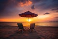 Two beach chairs and a little table with a colorful parasol directly on the beach during sunset created with generative AI