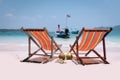 Two beach chairs on perfect tropical white sand and boat in the sea Royalty Free Stock Photo