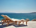 Two beach chairs on sea shore near water under blue clear sky. Stunning seascape background, summer vacation concept. Created with Royalty Free Stock Photo