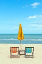 Two beach chairs with sun umbrella on beautiful beach. Royalty Free Stock Photo