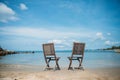 Two beach chairs on tropical shore Royalty Free Stock Photo