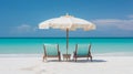 Two beach chairs and an umbrella on a beautiful white sand beach in front of the ocean on sunny day Royalty Free Stock Photo