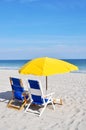 Two beach chairs and umbrellas on the beach Royalty Free Stock Photo