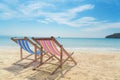 Two beach chairs on the white sand with blue sky and summer sea Royalty Free Stock Photo