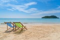 Two beach chairs on the white sand with blue sky and summer sea Royalty Free Stock Photo