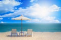 Two beach chairs and white umbrella with blue sky background on Royalty Free Stock Photo