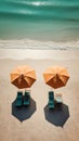 Two beach umbrella and deck chairs on stunning tropical beach sand near crystal clear ocean water. Summer vacation background.