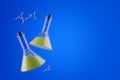 Two beakers over blue background, chemistry concept Royalty Free Stock Photo