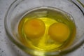 Two beaten eggs in a bowl, the baking materials.