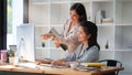 Two beautiful asian businesswoman analysing financial data on computer Royalty Free Stock Photo