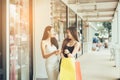 Two beautiful asian female friends enjoy shopping with holding paper bag Royalty Free Stock Photo