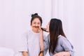 Two beautiful asian woman are having fun and making fake mustaches from hair,Happy and smiling