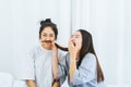 Two beautiful asian women are having fun and making fake mustaches from hair,Happy and smiling Royalty Free Stock Photo