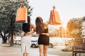 Two beautiful asian woman holding shopping bag at shopping market outdoor Royalty Free Stock Photo