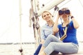 Two beautiful, attractive young girls with binocular on a yacht. Royalty Free Stock Photo