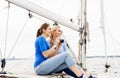Two beautiful, attractive young girls taking pictures on a yacht Royalty Free Stock Photo