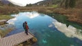 Two beautiful backpackers looking at the beautiful lake