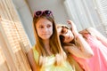 Two beautiful blond teenage girls having fun happy smiling Royalty Free Stock Photo