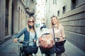 Two beautiful blonde women shopping on bike