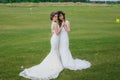 Two beautiful brides dancing on the green field Royalty Free Stock Photo