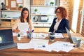 Two beautiful businesswomen smiling happy and confident Royalty Free Stock Photo