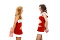 Two beautiful christmas girls isolated white background holding gifts. Royalty Free Stock Photo