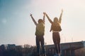 Two beautiful cool teenage girls 15-16 years old, best friends having fun, with their hands up Royalty Free Stock Photo