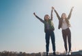 Two beautiful cool teenage girls 15-16 years old, best friends having fun, with their hands up Royalty Free Stock Photo