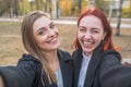 Two beautiful and cute girlfriends take a selfie.