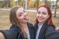 Two beautiful and cute girlfriends take a selfie.