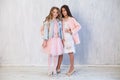 Two beautiful fashionable girl girlfriends in white pink dresses Royalty Free Stock Photo