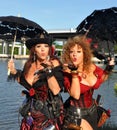 Two beautiful female pirates with parasols blow a kiss Royalty Free Stock Photo