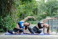 Two beautiful female sport wear exercise arm stretching yoga in garden. sport for health. woman training body balance. healthy