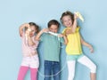 Two beautiful and funny girls and one cool boy playing with a lot of slime in front of blue background and having a lot of fun Royalty Free Stock Photo