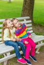 Two beautiful girlfriends posing in the garden Royalty Free Stock Photo