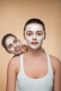 Two beautiful girls applying facial cream mask and Royalty Free Stock Photo